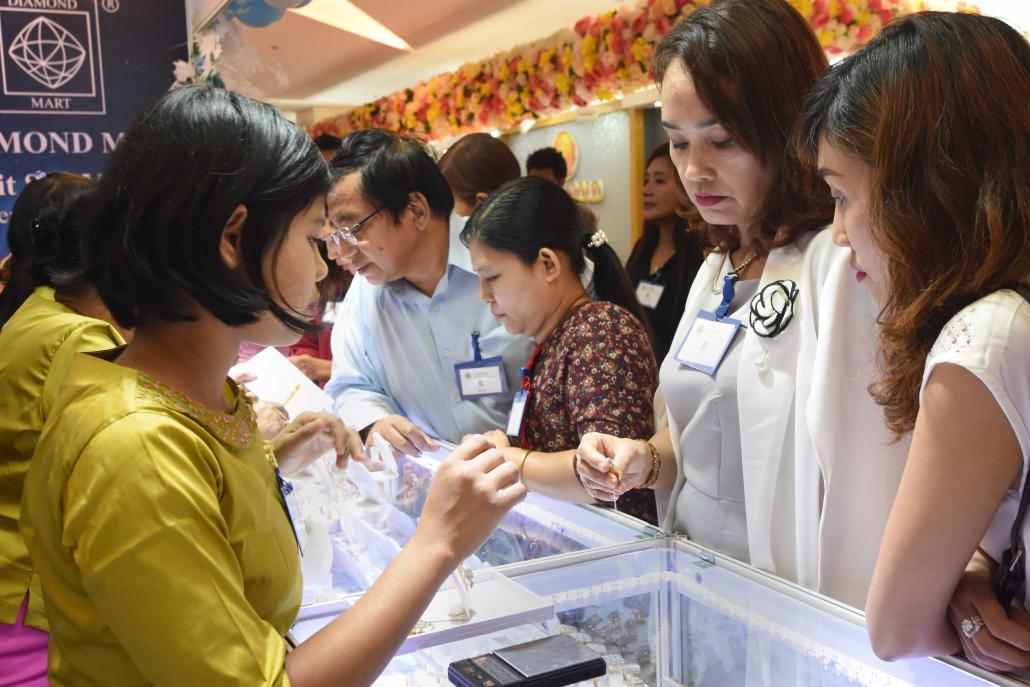 Customers browse display counters at a gems and jewellery fair held in Yangon from January 11 to 14. (Steve Tickner | Frontier)