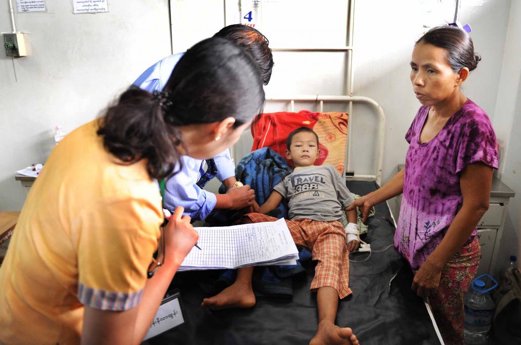 A young patient at Yangon Children's Hospital suffering from dengue receives an intravenous drip. (Steve Tickner / Frontier)