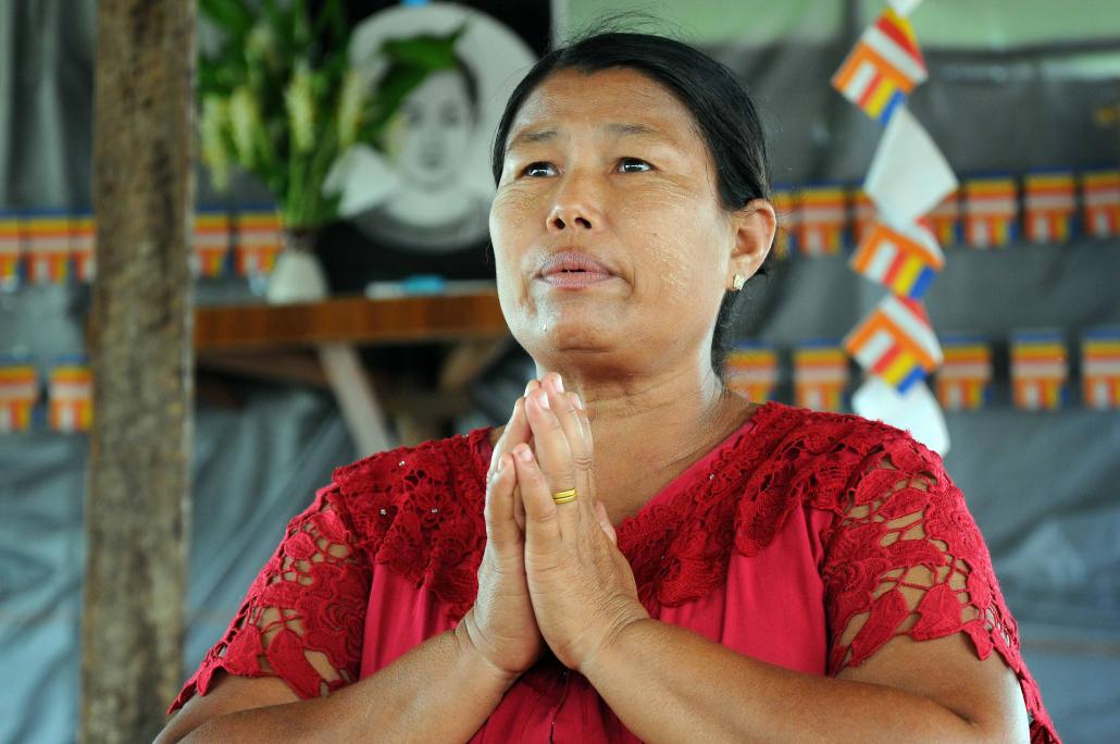 A woman prays at a bamboo monastery in Pyinmabin Ward, Mingaladon Township, marked for demolition by the government for not having building approval. (Steve Tickner / Frontier)