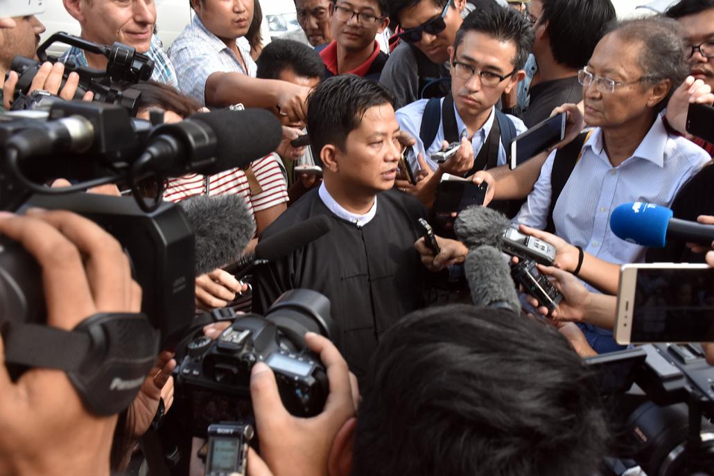 Defence lawyer U Than Zaw Aung (centre) speaks to reporters outside Yangon Region High Court. (Steve Tickner | Frontier)