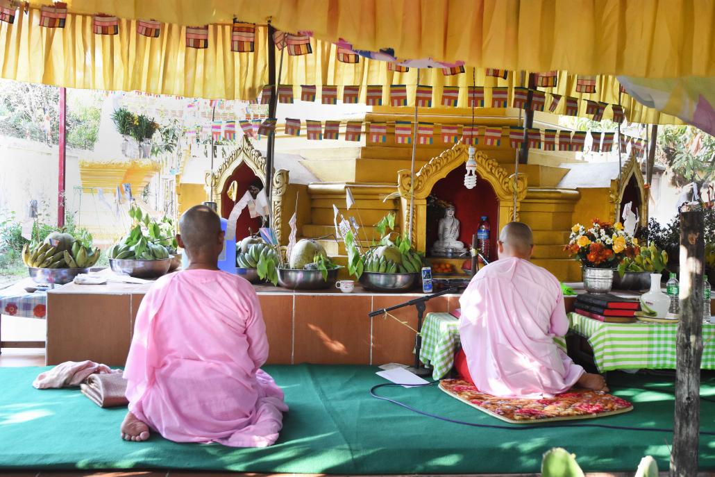 Nuns praying at the Metta Gon Yee nunnery in Yangon's Thanlyin Township. (Steve Tickner | Frontier)