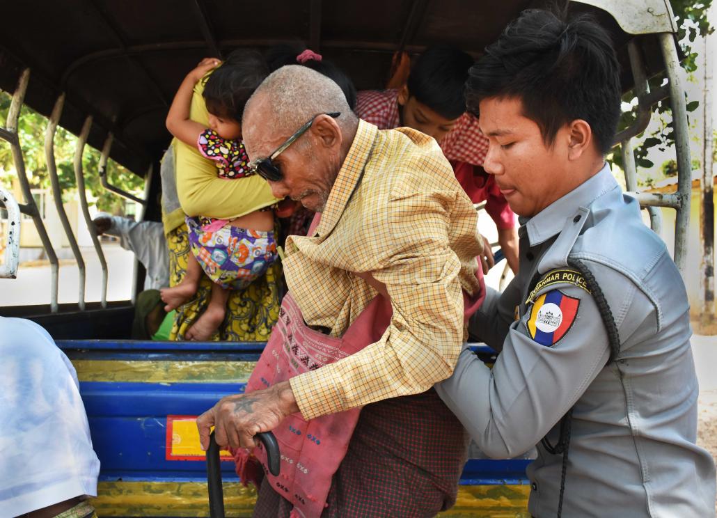 Police help U Khwe Lay out of a pickup truck at the Hmawbi social care centre on February 9. Twice a month police drop off people they have found begging in urban Yangon. (Steve Tickner | Frontier)