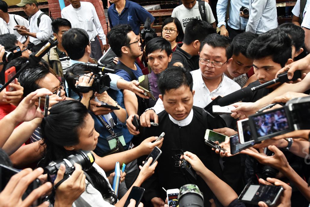 Defence lawyer Than Zaw Aung surrounded by reporters after the court session on August 27. (Steve Tickner | Frontier)