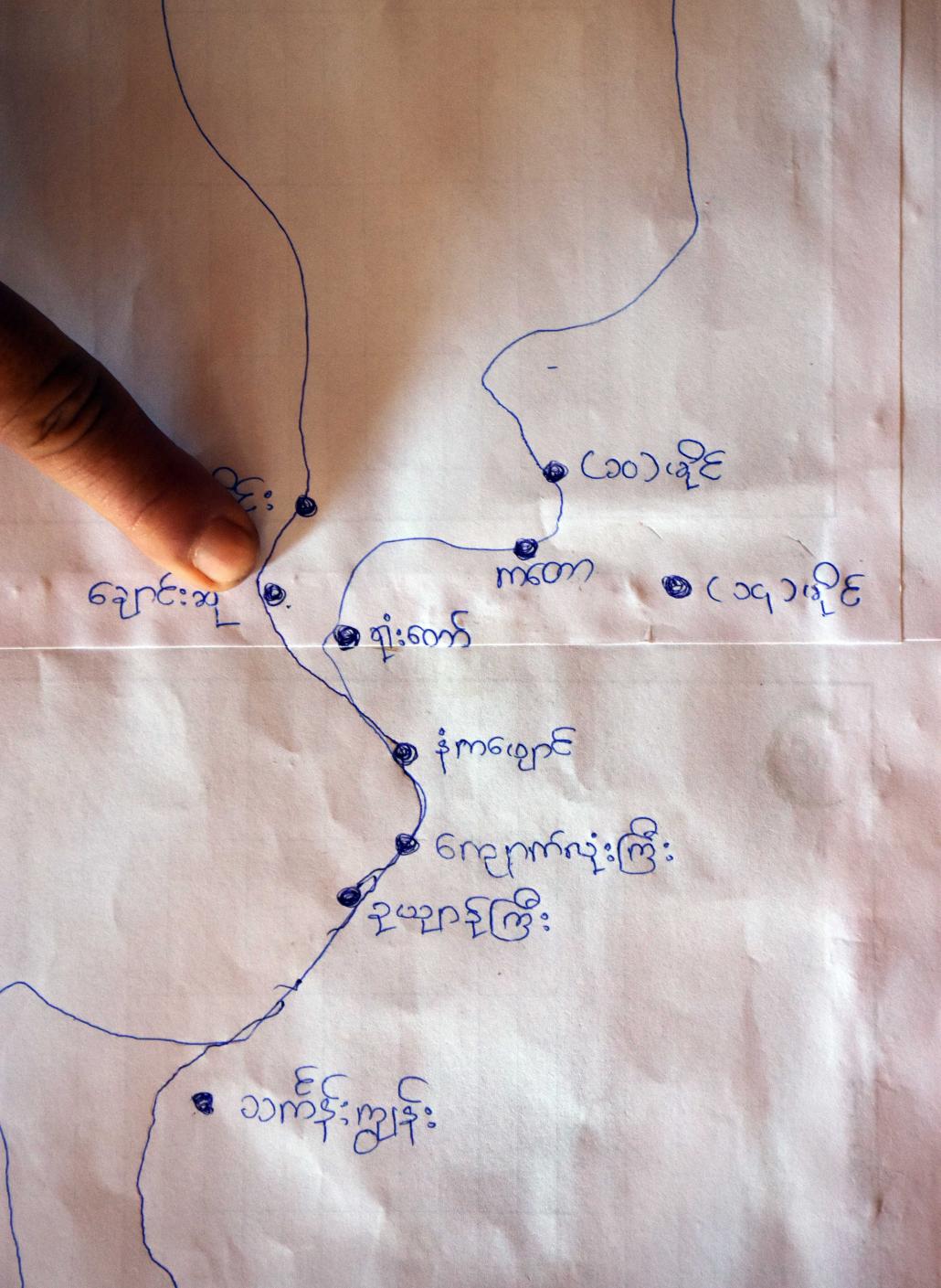 A local resident points to a home-made map showing 10 villages that could be affected if a national park is created along the Lenya River in Tanintharyi Region. (Steve Tickner | Frontier)
