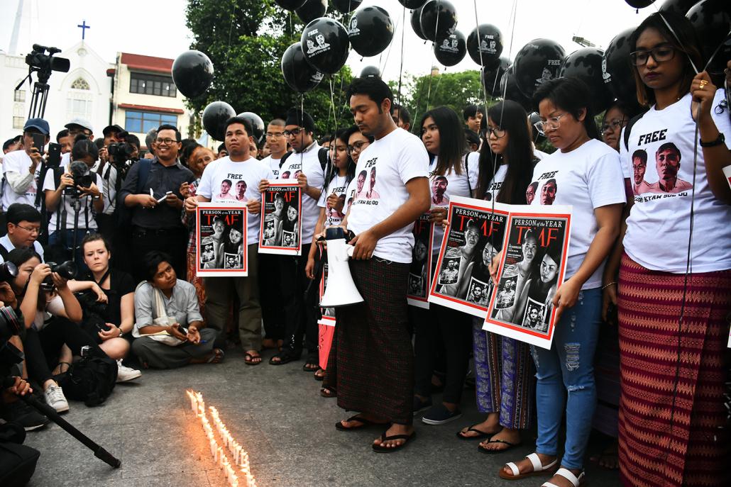 Free speech advocate Maung Saungkha stands with a loudspeaker before protesters demanding the release of Ko Wa Lone and Ko Kyaw Soe Oo. (Steve Tickner | Frontier)