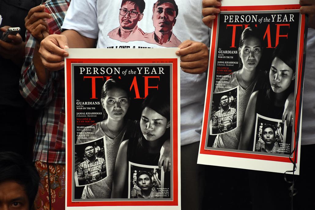 Protestors hold up copies of a Time magazine cover that presents Ko Wa Lone and Ko Kyaw Soe Oo as part of a group of persecuted or murdered journalists that have collectively been given the title of Time's "Person of the Year". (Steve Tickner | Frontier)