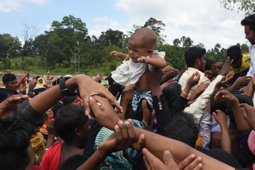 People wait for food to be distributed at Kutupalong Refugee Camp in Bangladesh. (Steve Tickner | Frontier)