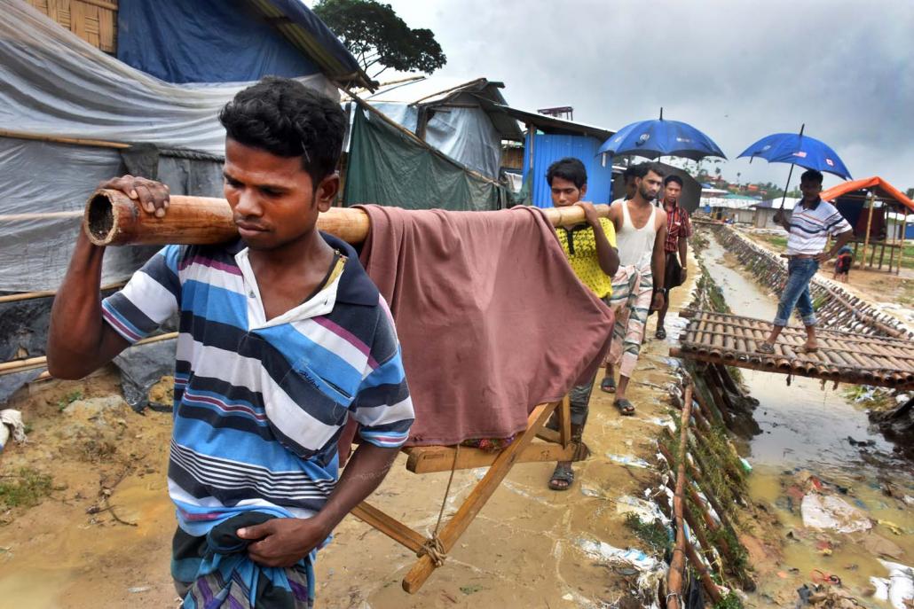 A sick patient is carried out of Balukali towards a nearby health centre. (Steve Tickner | Frontier)