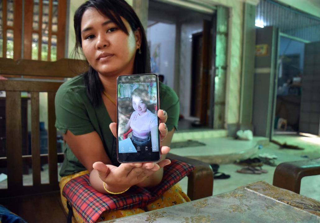 Ma Hnin Wai Thi shows a photo of the person she alleges she transferred the money to. (Steve Tickner | Frontier)