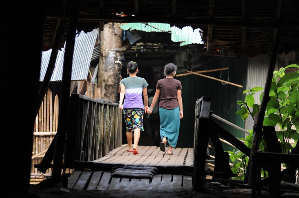 Two young children walk through one of the Mae La camp’s winding lanes. (Steve Tickner / Frontier)