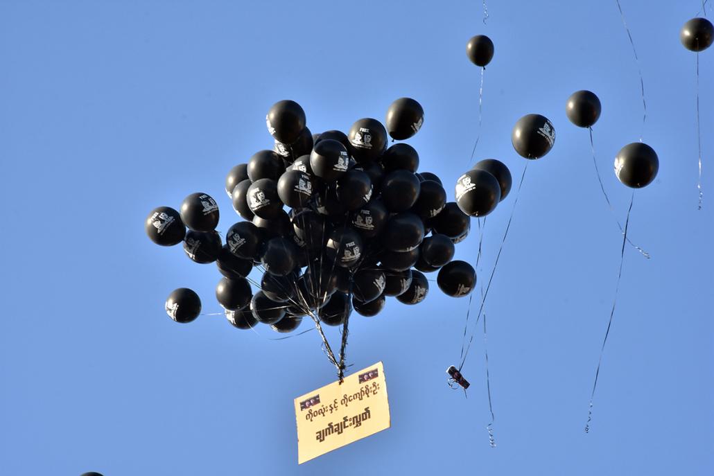 Black balloons stencilled with the faces of the two journalists were released into the air. (Steve Tickner | Frontier)