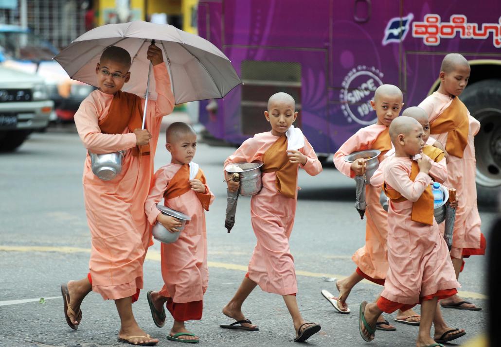 Nuns cross a road in downtown Yangon. Nuns are often shown less respect than monks, in part because they are not ordained. (Steve Tickner | Frontier)