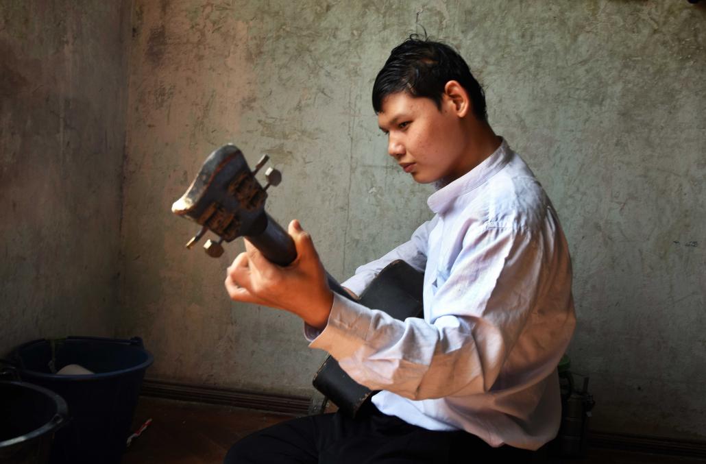 Mg Zaw Mlutaw, 16, practises guitar in his living quarters at the Myanmar Christian Fellowship for the Blind in Yangon's Mayangone Township. (Steve Tickner | Frontier)