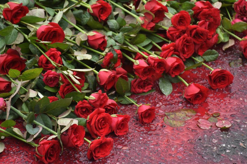 Rose are laid on the road where students were killed near Yangon's Sule Pagoda. (Steve Tickner | Frontier)