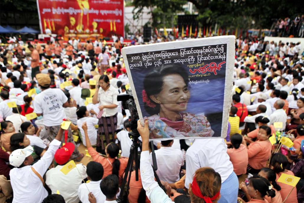 A supporter holds an image of Daw Aung San Suu Kyi at a May 2014 rally to amend the 2008 Constitution. The event was jointly organised by the NLD and 88 Generation. (EPA)