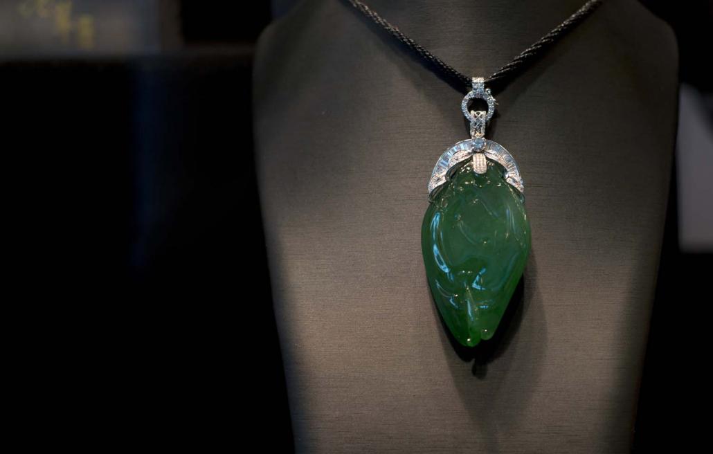 A pendant made from Myanmar jade on display at the Hong Kong Jewellery and Gem Fair in 2013. Although Myanmar law requires miners to sell their jade at emporiums in Nay Pyi Taw, most is instead smuggled to China. (AFP)