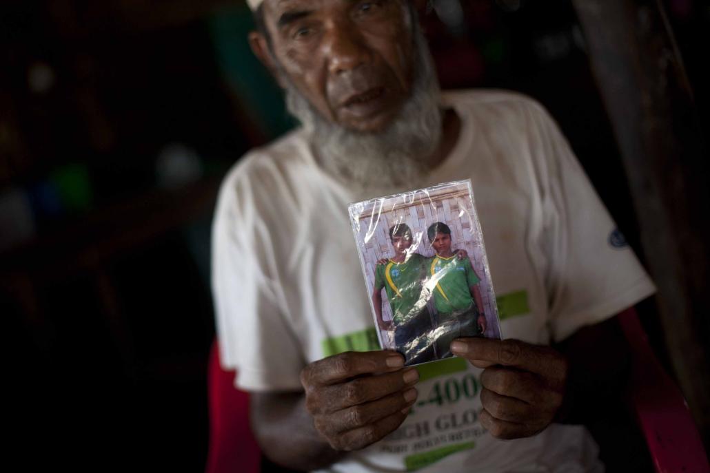 A Muslim man who identifies as Rohingya holds a picture of his son in May 2015. The man, a resident of an IDP camp in Sittwe, said his son was being held at a human trafficking camp in Malaysia. (AFP)
