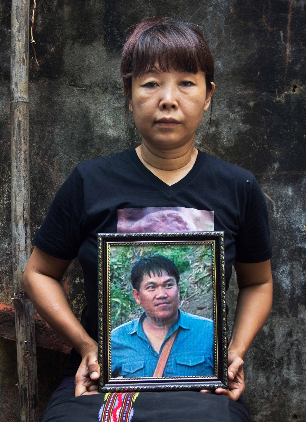 Daw Thandar, the wife of journalist Ko Par Gyi, holds a picture of her husband who was killed by the military in 2014. (Letyar Tun / Framing the Transition)