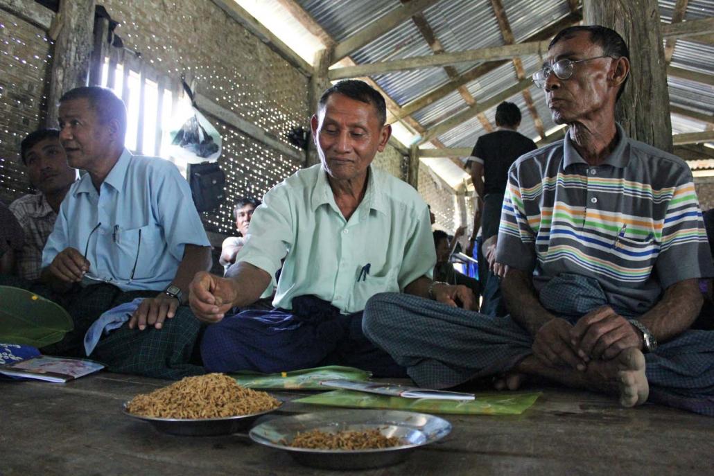 Farmers in central Rakhine State receive training from Tat Lan staff on how to choose the best seeds for their land. (Tat Lan)