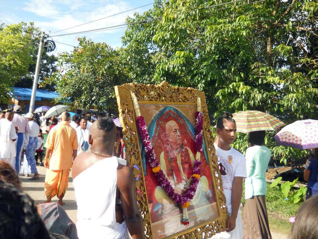 The biggest annual festival for Hare Krishna devotees in Myitkyina is the Ratha Yatra, a Hindu procession that happens in June or July. In this photo, devotees carry a portrait of A.C. Bhaktivedanta Swami Prabhupada. (Emily Fishbein | Frontier)