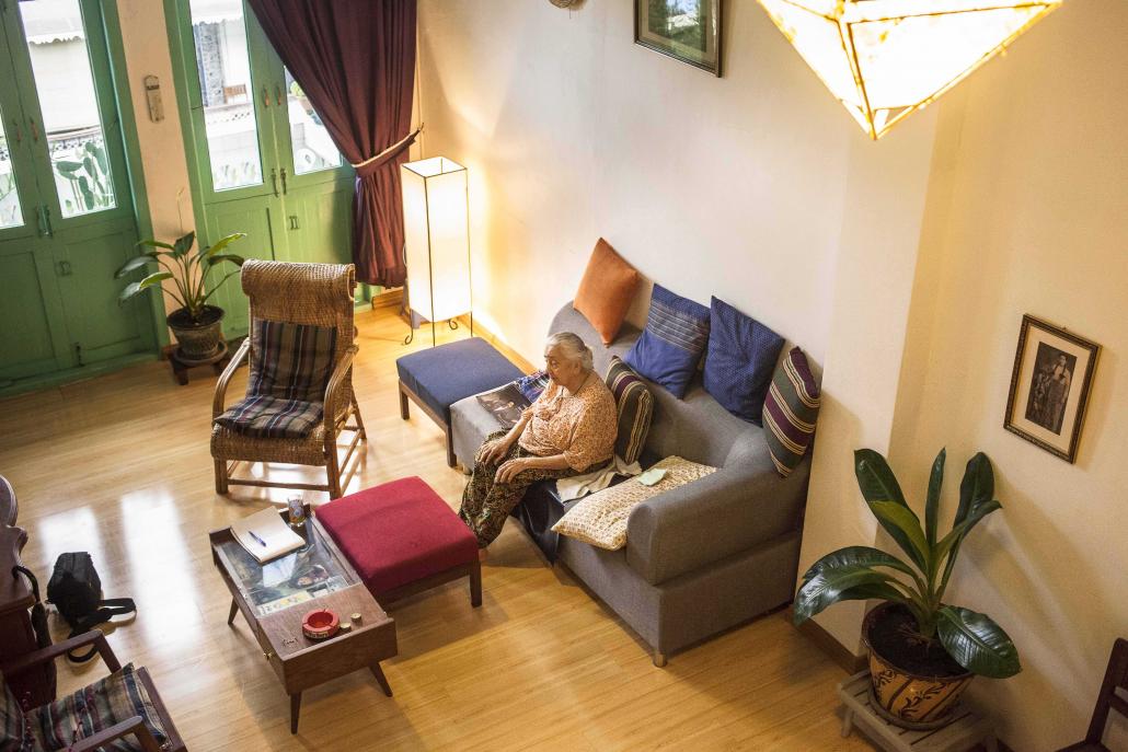 Ghulam Hla Tin's mother sits inside the front room of the family home in Yangon's Bogalay Zay Street. (Theint Mon Soe aka J | Frontier)