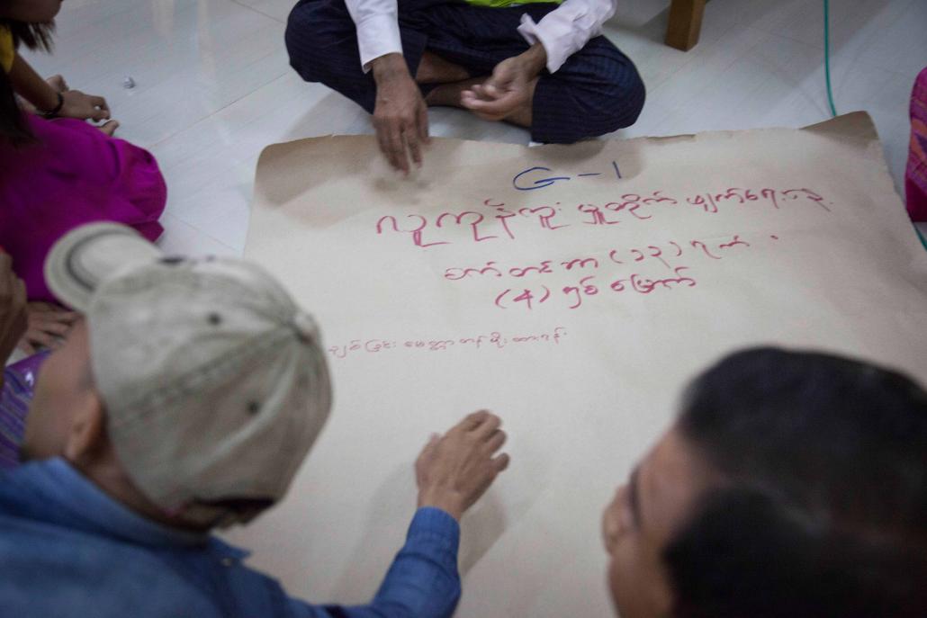 Former trafficking victims write down messages for the government outlining their needs for the future. (Theint Mon Soe — J / Frontier)