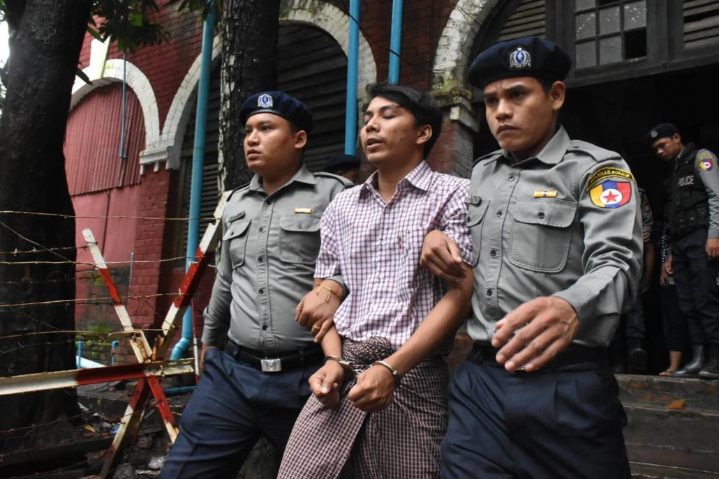 Ko Kyaw Soe Oo is escorted by police from the courtroom today. (Steve Tickner | Frontier)