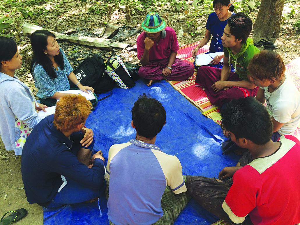 A group of rubber tappers trialling mosquito-repellent clothing in Mon State. (Supplied)