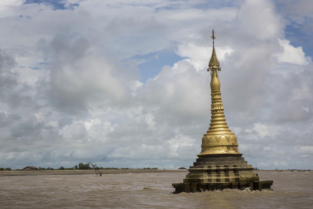 A pagoda built in a mangrove that was chopped down 15 years ago is being swallowed by the sea. (Taylor Weiden / Frontier)