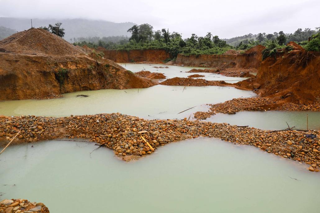 An abandoned mine, closed by the government in mid-August, sits flooded by monsoon season rains. Sites like this are often foraged by small-scale miners. (Victoria Milko / Frontier)