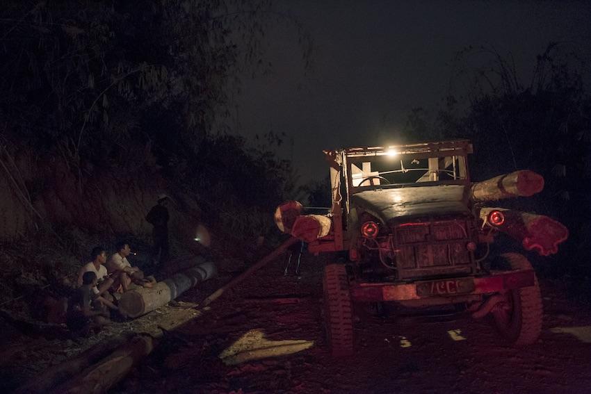 Men load logs they have cut down from the forests in the Banchaung valley area onto a truck. (Minzayar Oo / WWF)