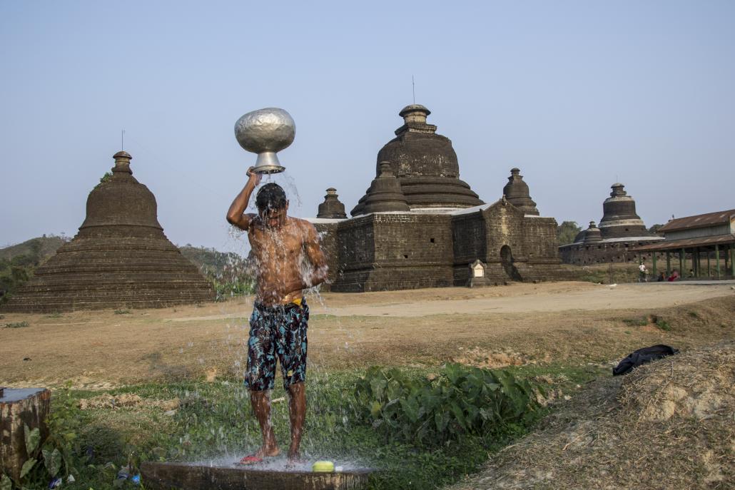 A man washes himself outside a Mrauk U temple. (Mratt Kyaw Thu / Frontier)