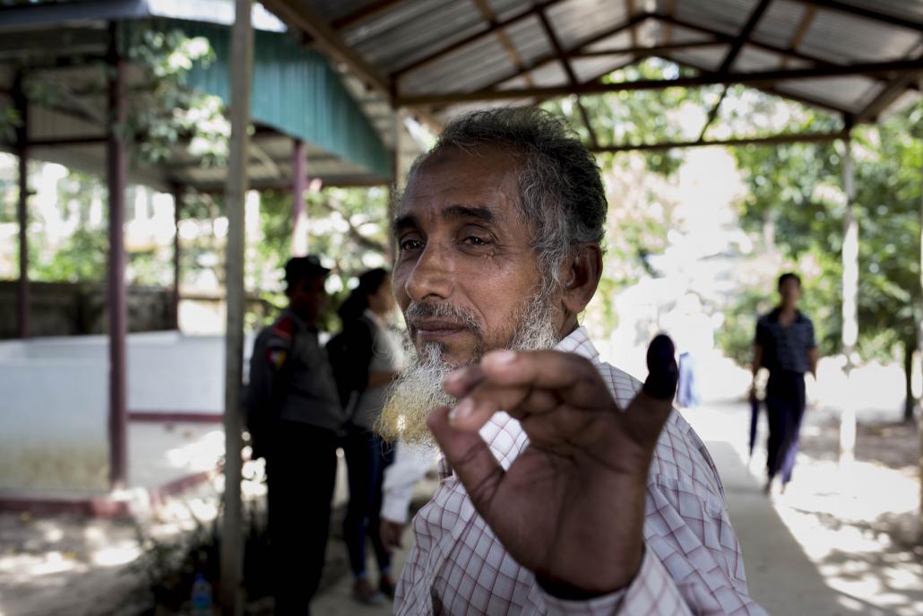 A Muslim voter displays his ink-stained finger in Yangon's Thingangyun Township on election day. (Ann Wang / Frontier)