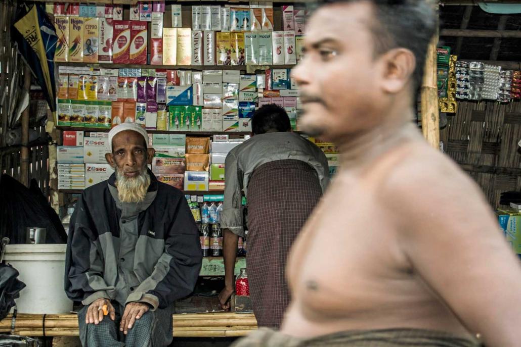 A Muslim man waits at a pharmacy in a Rohingya IDP camp on the outskirts of Sittwe. (Maro Verli | Frontier)