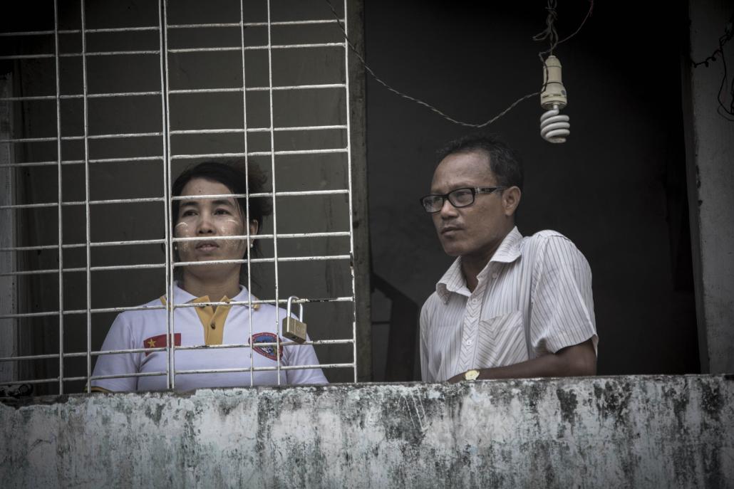 Husband and wife activist duo Ma Su Su Nyay and Ko Marky on the balcony of their Yangon apartment. (Maro Verli / Frontier)