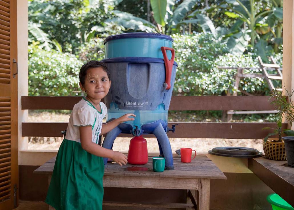 A student pours a cup of water at the school in Pa Yaw He, Thanbyuzayat Township, Mon State. (Nyein Su Wai Kyaw Soe | Frontier)
