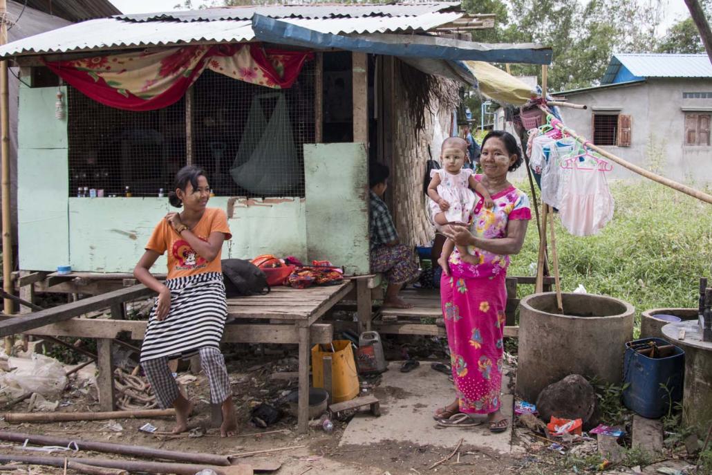 Shwepyithar Township resident Daw Su Su Hlaing, 38, holds her infant daughter. (Nyein Su Wai Kyaw Soe | Frontier)