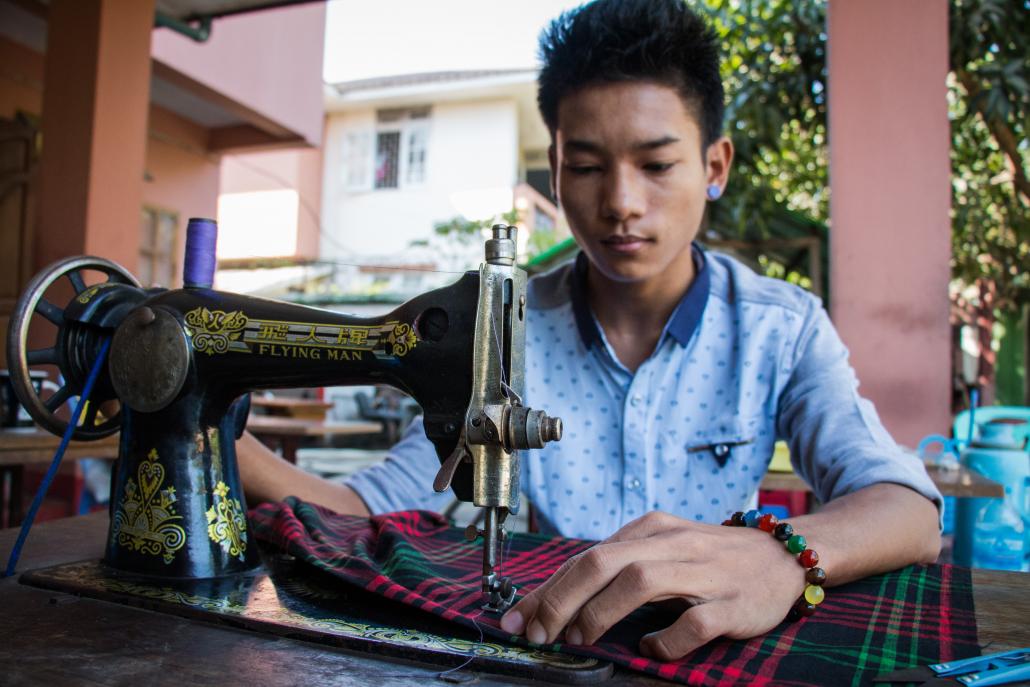 A 16-year-old boy who was born with HIV attends a sewing class run by Phoenix Association in Hlaing Tharyar Township. (Nyein Su Wai Kyaw Soe | Frontier)