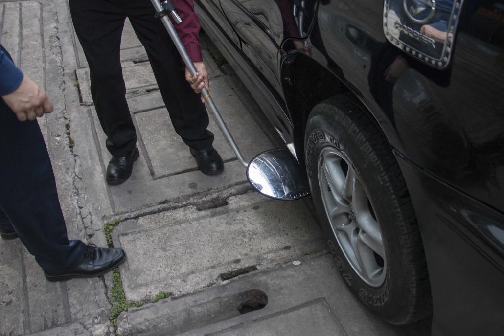 A security guard is trained by Exera to search for explosive devices under a car. (Nyein Su Wai Kyaw Soe | Frontier)