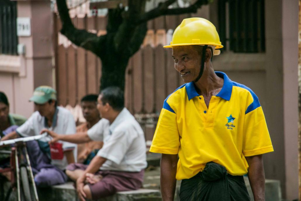 Trishaw driver Ko Naing works as a volunteer clearing traffic in a busy street in Yangon's Tarmwe Township. (Nyein Su Wai Kyaw Soe / Frontier)