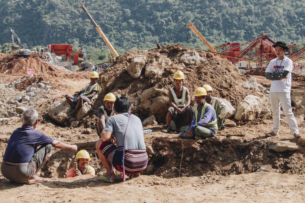 Workers wearing China Road and Bridge Construction helmets take a break at the Mount Lun Nya quarry. (Nyein Su Wai Kyaw Soe | Frontier)