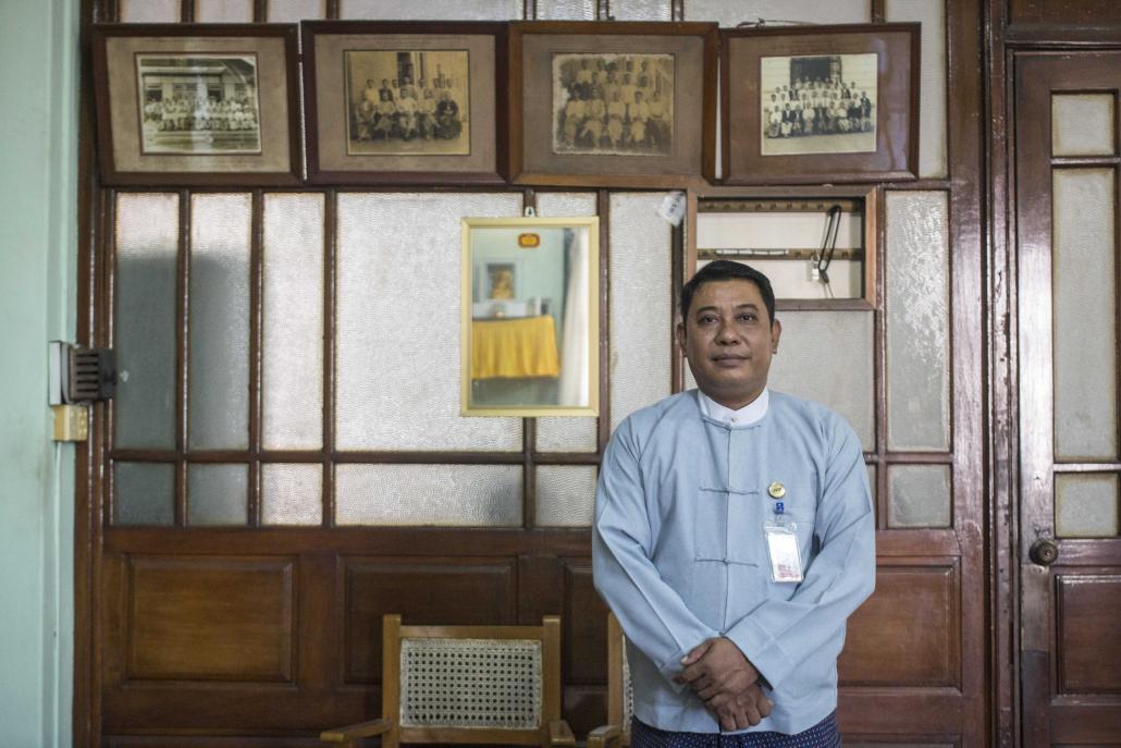 U Thaung Naing Soe in his colonial-era office on Pansodan Street, the walls covered in photos of his predecessors. (Nyein Su Wai Kyaw Soe | Frontier)