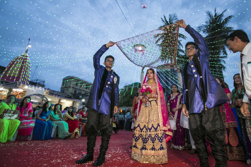 Shilpa Pradhan's brothers shield her with fabric and send her to the groom, as per Hindu tradition. (Nyein Su Wai Kyaw Soe | Frontier)