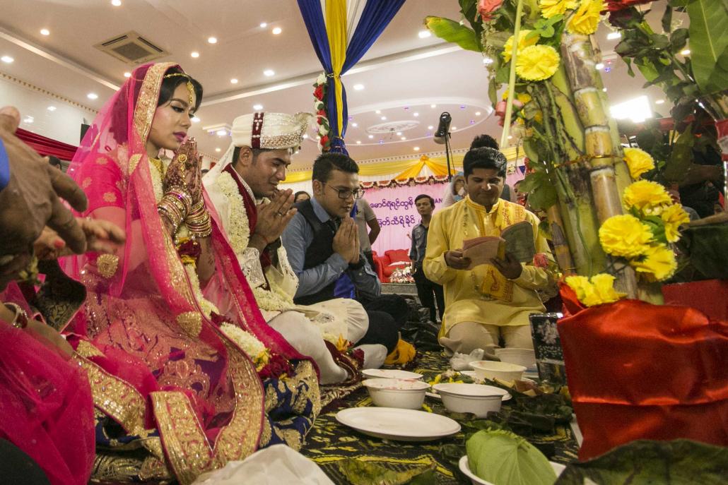 The bride, groom and relatives pray at the start of the June 29 wedding ceremony. (Nyein Su Wai Kyaw Soe | Frontier)