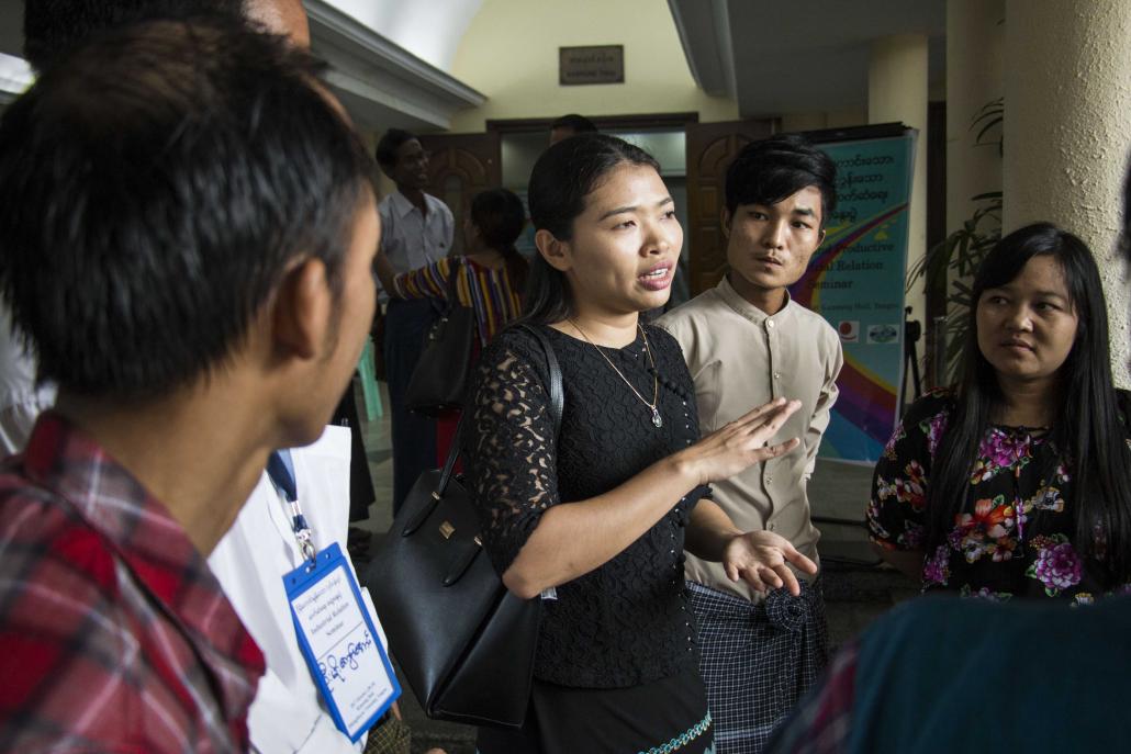 Confederation of Trade Unions Myanmar executive member Ma Khaing Zar Aung, centre, speaks to labour leaders during a seminar in Hlaing Tharyar on October 28 aimed at improving relations between employers and workers. (Nyein Su Wai Kyaw Soe | Frontier)