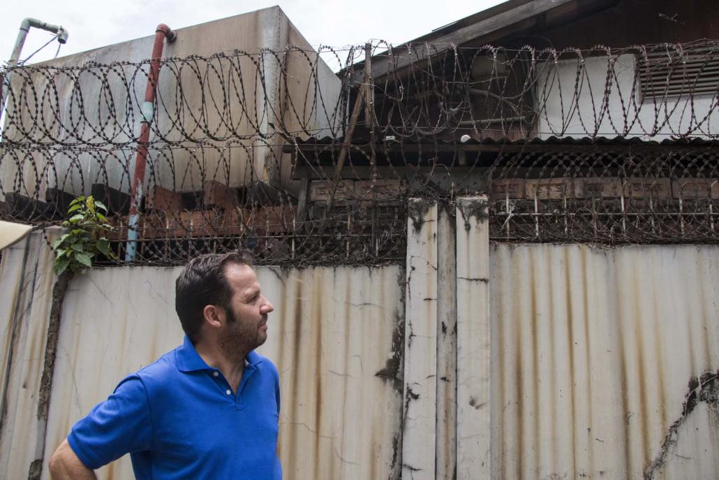 Mr Paolo Cerati stands in front of a rubber factory that operates next to his house in a residential area of Yangon’s Mayangone Township. (Nyein Su Wai Kyaw Soe | Frontier)