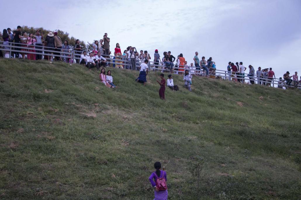 Visitors stand on a viewing mound in Bagan to watch sunset. The mounds were built after authorities banned visitors from climbing on the pagodas. (Nyein Su Wai Kyaw Soe | Frontier)