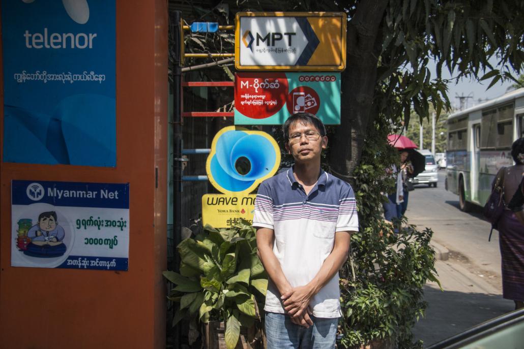 Ko Aung San Thwin owns a small mobile phone store in Hlaing Township and is an agent for various mobile money operators (Nyein Su Wai Kyaw Soe | Frontier)