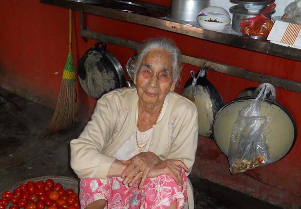 Daw Bhagwant Kaur, 92, helps to prepare lunch for the 20 relatives and workers at her home. She is the oldest member of Myitkyina's Sikh community and traces her ancestry to a soldier who served with the British army. (Emily Fishbein | Frontier)