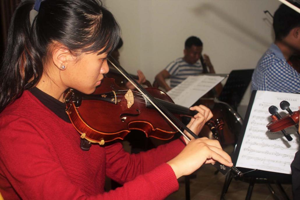 Violinist Seng Lu Awng rehearses at Shatapru Kachin Baptist Church. (Eno Jude | Frontier)